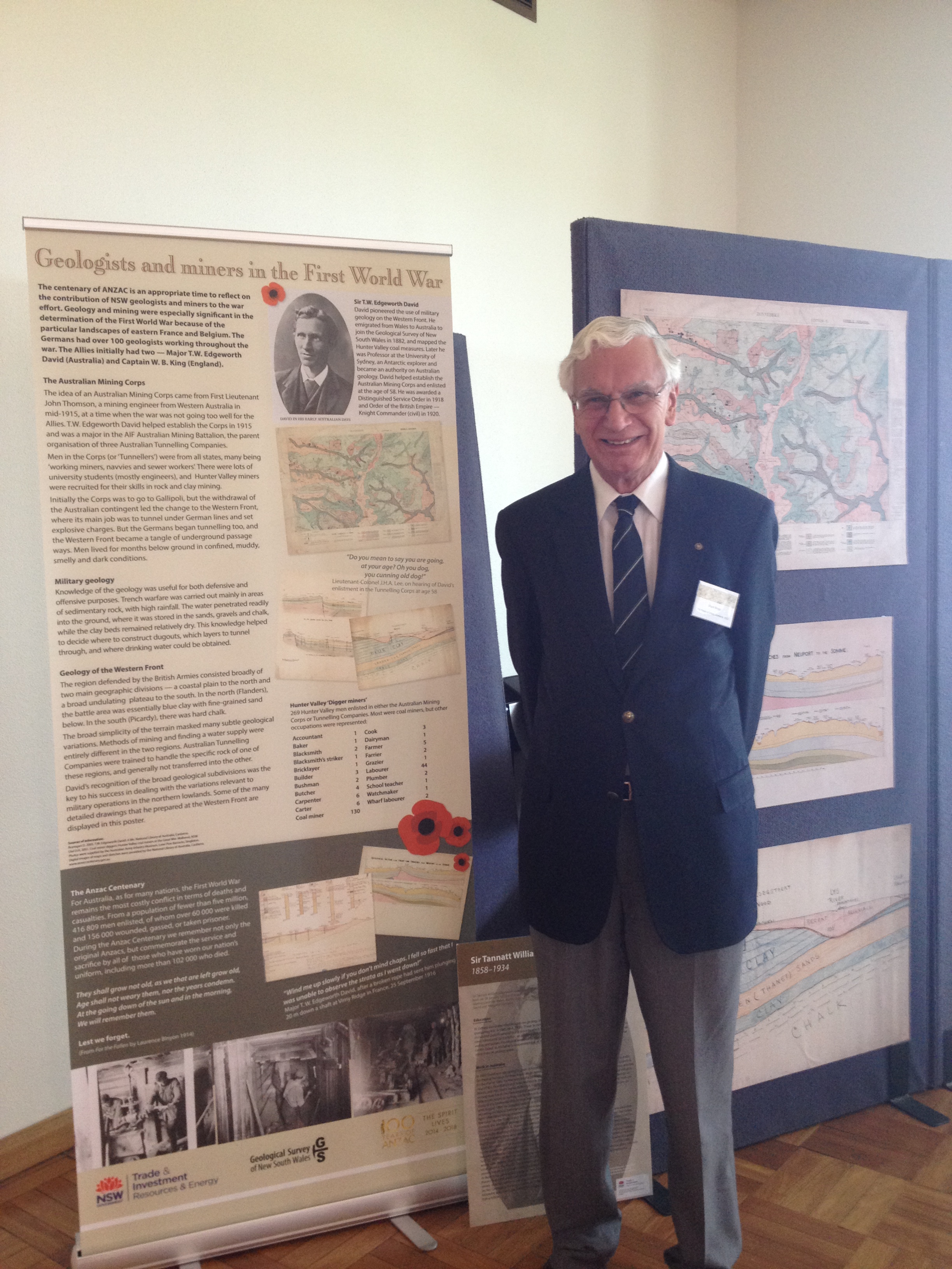 Dr Stuart Braga standing in front of the Geologist and Miners of the First World War display that included maps drawn by Edgeworth David
